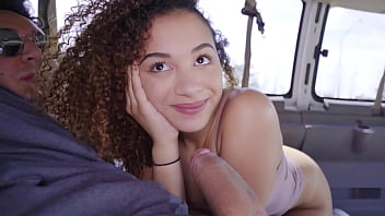 A charming and lovely African American teenager gives a blowjob to a large penis before engaging in rough sexual intercourse in a van