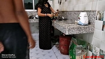 A mature wife in a black dress gets fucked in the kitchen